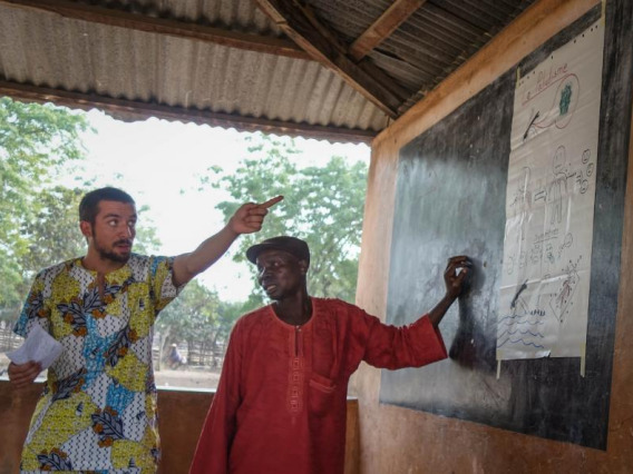 Jake, at left, leading a session on malaria prevention