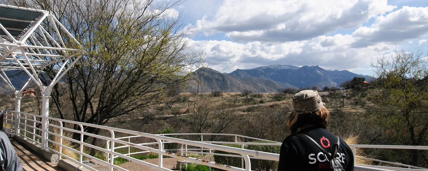 Student walking along Biosphere2 taking in the scenery